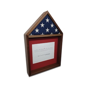 May include: A wooden shadow box with a red felt background and a glass front. The box is designed to hold a folded American flag. The box is 8 1/2 inches by 11 inches and is landscape oriented. The text "8 1/2" x 11" Landscape" is printed on the felt background.
