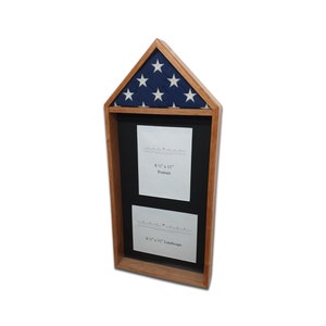 May include: Wooden flag display case with a triangular top featuring a blue field with white stars. The case has a black interior with two openings for 8.5" x 11" documents, one in portrait and one in landscape orientation. The frame is made of light brown wood.