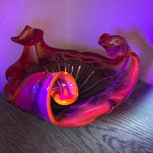 Impresive red glass shining under uv light vessel