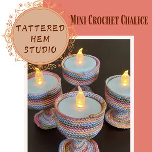 May include: Three crocheted candle holders in a rainbow colour pattern. The holders are made with a variety of colours, including pink, yellow, orange, green, and blue. The candle holders are sitting on a dark brown surface. The image includes the text "MINI CROCHET CHALICE" and "EASY LEVEL PDF CROCHET PATTERN".