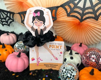 May include: A Halloween display with a card showing a ballerina in a bat costume, surrounded by orange and pink pumpkins, disco balls, and decorative fans. The card reads "Trick or Treat, Point Your Feet!"