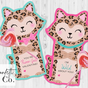 May include: Two Valentine's Day cards featuring a cartoon leopard with a pink bow and a heart-shaped lollipop. The card on the left says "You're Purrr-fect Valentine!" and the card on the right says "I'm Wild About You!"
