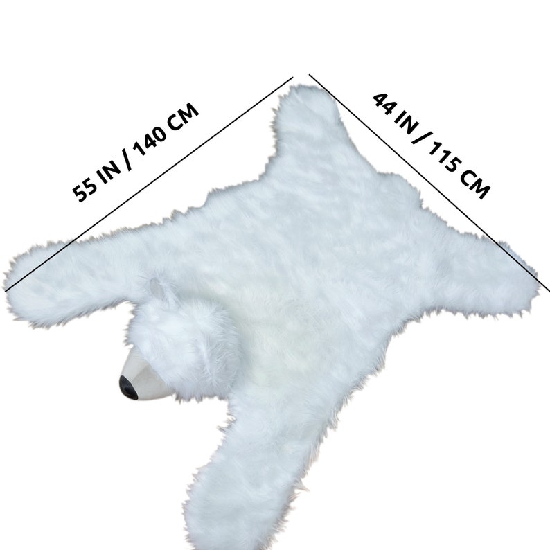 May include: White faux fur polar bear rug with a 55 inch by 44 inch measurement.