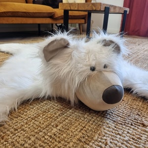 Mat, carpet for a polar bear child's room. White furry teddy bear