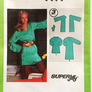 May include: Simplicity sewing pattern number 9191 for a green tunic with long sleeves. The pattern is for misses sizes 14. The pattern includes three pieces and is labeled "Super Jiffy".