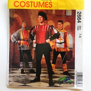 Puede incluir: Un patrón de costura vintage para un disfraz medieval. El patrón es para las tallas 7-8 e incluye instrucciones para hacer una túnica, pantalones y un sombrero. El patrón es de McCall's Costumes y tiene el número 2664.