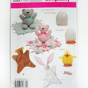 May include: Simplicity sewing pattern number 1681, featuring a reversible egg that turns into a chick, a brown bear, a pink bear, a white bunny, and a yellow chick. The pattern is for one size and includes instructions for making all five plush toys.