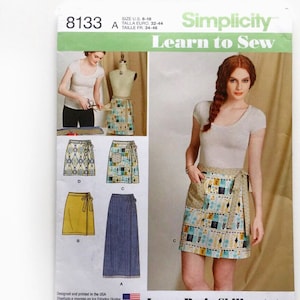 May include: Simplicity Learn to Sew pattern 8133. The pattern includes instructions for making wrap skirts. The image shows a woman wearing a wrap skirt with a pocket. The pattern also shows different skirt designs and includes a list of basic sewing skills.