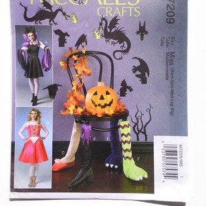May include: A McCall's Crafts sewing pattern, M7209, featuring Halloween costume designs. The cover displays a pumpkin on a chair, with costume illustrations and dragon silhouettes. The size range is Miss (Xsm-Sml-Med-Lrg-Xlg).