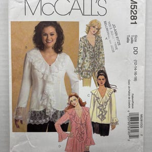 May include: A McCall's M5281 sewing pattern envelope for a long-sleeve top with a ruffled V-neckline and lace trim. The envelope displays four variations of the top in white, floral, yellow, and pink, labeled A, B, C, and D, with size DD (12-18).
