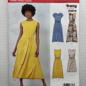 May include: New Look sewing pattern N6618 for a sleeveless dress with a tie waist. The envelope displays a model wearing a solid yellow version and illustrations of three variations: a solid blue, a floral print, and a solid yellow dress.