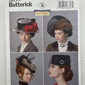 May include: Butterick B6397 sewing pattern envelope featuring four distinct hat designs. The hats include a black brimmed hat with red flowers, a large black hat with brown feathers, a small black hat with netting and feathers, and a black pillbox hat.