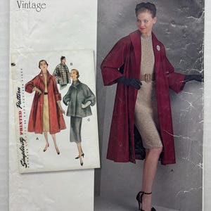 May include: A Simplicity sewing pattern envelope R10147 R5 for 1950s clothing. The cover features a maroon coat, a beige dress, and black gloves. Text includes Simplicity, 1950s Vintage, and size information for U.S. 14-22, Euro 40-48, and Fr. 42-50.