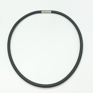 May include: A black rubber necklace with a magnetic clasp.