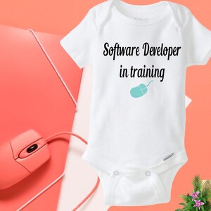 May include: White baby onesie with black text that reads "Software Developer in training" and a blue computer mouse icon.
