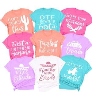 May include: A set of ten t-shirts with various designs and phrases related to a fiesta theme. The shirts are in different colors, including pink, blue, white, and coral. The phrases on the shirts include "Can't Touch This", "DTF Down to Fiesta", "Shake Your Maracas", "Fiesta Like There's No Manana", "Tequila Made Me Do It", "Tacos and Tequila", "Adios Bitchathos", "Nacho Average Bride", and "Let's Get Smashed".