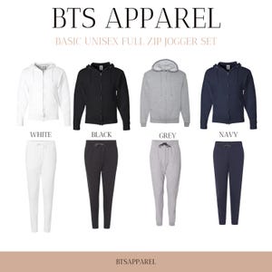 May include: A set of four unisex full zip jogger sets in white, black, grey, and navy. The sets feature a full zip hoodie and matching jogger pants.