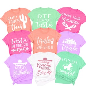 May include: Nine different t-shirts with various designs and text related to a fiesta theme. The shirts are in various colors, including pink, green, white, and orange. The text on the shirts includes phrases like "Can't Touch This", "DTF Down to Fiesta", "Shake Your Maracas", "Fiesta Like There's No Manana", "Tequila Made Me Do It", "Tacos and Tequila", "Adios Butchathos", "Nacho Average Bride", and "Let's Get Smashed".