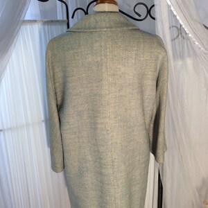 May include: A light blue blazer with a textured woven fabric. The blazer has a classic collar and long sleeves.