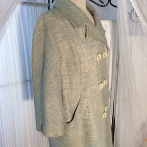 May include: A light blue blazer with a white and light blue patterned design. The blazer has a double breasted closure with white buttons and a single pocket on the left side.