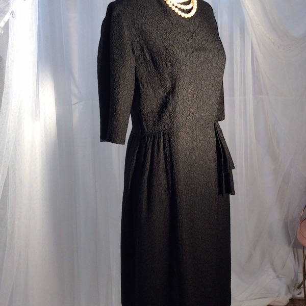 Vintage 1950’s - 1960’s black sheath, little black dress, with 3/4 sleeves and hip embellishment