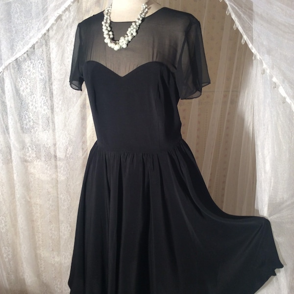 1980’s CDC Evening label black cocktail dress with sheer sleeves and sweetheart bodice