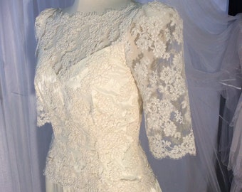 Vintage 1980’s Alencon/ Chantilly lace and ivory satin wedding dress with 3/4 sleeves and tiny buttons.