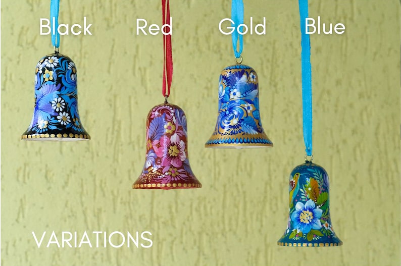 May include: Four hand-painted wooden bells with floral designs. The bells are black, red, gold, and blue. The bells are hanging from ribbons of the same color as the bell. The text "VARIATIONS" is at the bottom of the image.