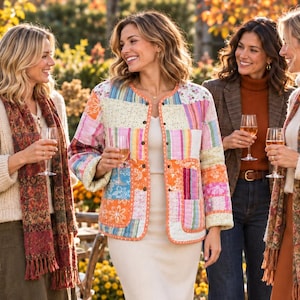 May include: A quilted jacket featuring a patchwork design with various floral and striped patterns in shades of pink, orange, blue, and white. The jacket has a round neckline, long sleeves, a button-front closure, and two front patch pockets.