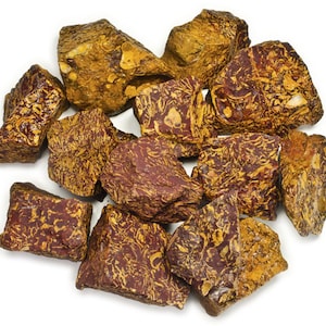 May include: A collection of red and yellow jasper stones with a swirling pattern. The stones are rough and have a natural, unpolished finish.