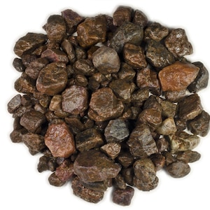May include: A close-up of a pile of small, brown and reddish-brown gravel stones. The stones are irregularly shaped and have a rough texture.