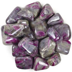 May include: A collection of tumbled pink and grey ruby in zoisite stones. The stones are smooth and polished, with a variety of shapes and sizes.