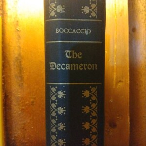 May include: A black book with gold lettering on the spine. The title is "The Decameron" by Boccaccio.