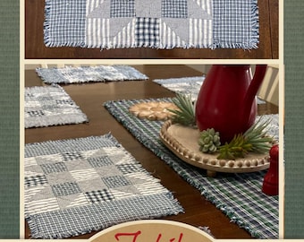 May include: A set of blue and white patchwork placemats with frayed edges. The placemats are arranged on a wooden table with a red pitcher, a green plant, and a wooden tray with white beads.