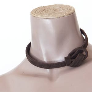 May include: A brown suede choker necklace with a knotted design.