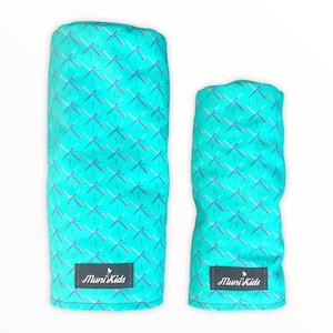 May include: Two turquoise blue golf club headcovers with a white and blue geometric pattern. The headcovers have a small logo that says "Muni Kids" on them.