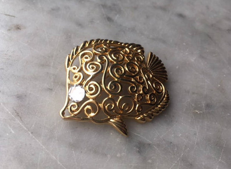 Vintage Trifari Figural Angel Fish Brooch Pin Gold Tone Rhinestone Eye Openwork Scroll Swirl Tropical Undersea Marine Animal Costume Jewelry