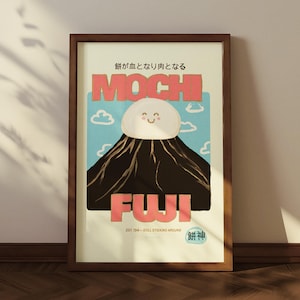 May include: A framed art print featuring a whimsical illustration of Mount Fuji with a mochi-shaped cloud. The text reads "MOCHI FUJI" in coral letters, with Japanese text above and below. The artwork is set against a light blue sky with cartoon clouds.