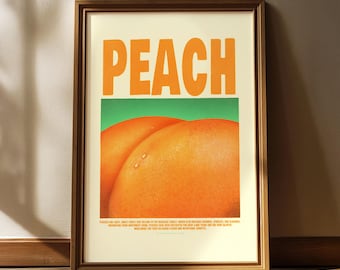 May include: Framed art print featuring the word "PEACH" in large orange letters above a close-up of two ripe peaches against a green background. The print is in a wooden frame and is displayed on a wall.