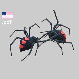 May include: Two black crochet spiders with red heart-shaped markings on their abdomens. The spiders are posed as if they are fighting or dancing.