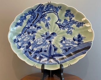 Antique and rare oval Chinese porcelain dish with floral decoration in blue monochrome on a celadon background, 20th century, signed, 33 cm