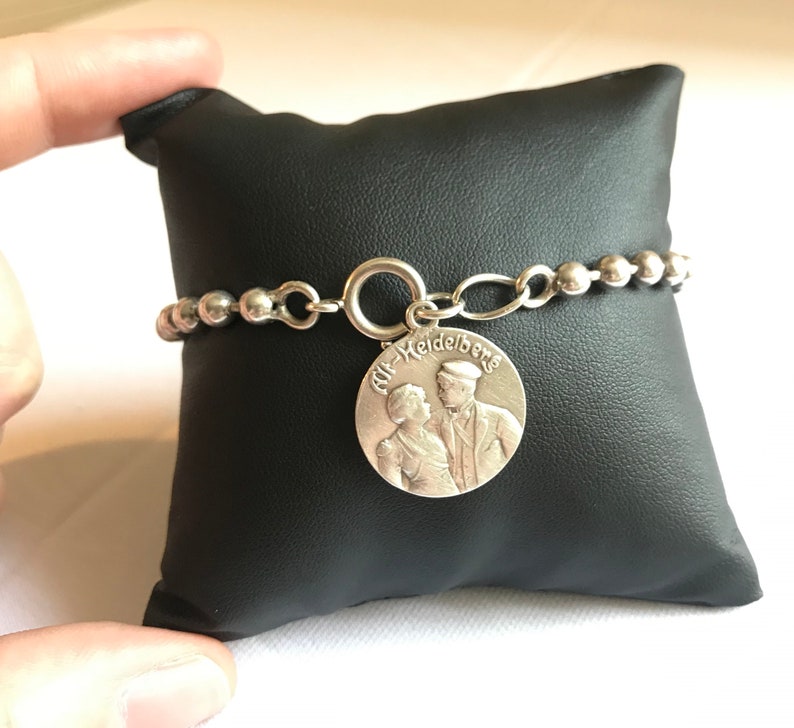 Silver pearl bracelet with 1909 medallion
