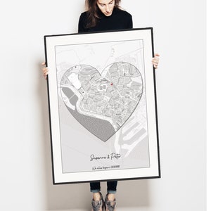 May include: A black and white map print with a heart-shaped outline around a city. The text "Susanne & Peter" and "We all began..." is at the bottom of the print.