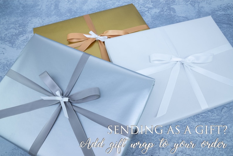 May include: Three gift boxes wrapped in different colors: silver, gold, and white. Each box is tied with a ribbon and bow. The text "SENDING AS A GIFT? Add gift wrap to your order" is at the bottom of the image.