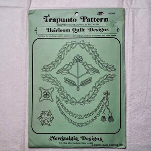 May include: A light green paper pattern envelope titled Trapunto Pattern Heirloom Quilt Designs by Newstalgia Designs. The front features black line art illustrations of birds, floral motifs, and decorative borders, with text including #D206.