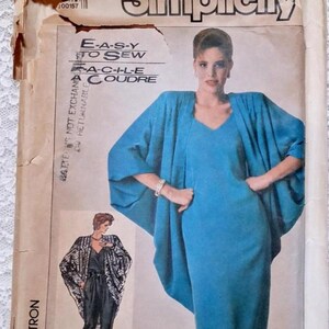May include: Simplicity sewing pattern featuring a blue dress and matching cape. The pattern includes sizes U (16+18+20). The text "E-A-S-Y TO SEW" is visible. The pattern is for a dress and cape ensemble.
