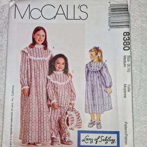 May include: McCall's sewing pattern featuring children's sleepwear designs. The pattern includes options for a long nightgown, a pajama set, and a short nightgown. The sleepwear has a red and white striped pattern with white lace trim. The pattern is size medium (8, 10).