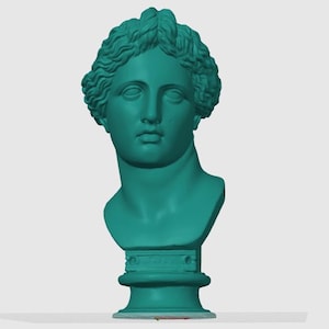 Puede incluir: Busto turquesa de una figura clásica, probablemente una diosa o noble. La escultura presenta rasgos faciales detallados y cabello rizado, montada sobre una base de pedestal. El busto es de color sólido y destaca sobre un fondo liso.