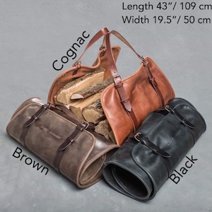 May include: Three leather bags in cognac, brown, and black. The cognac bag is open and filled with firewood. The brown and black bags are rolled up. The bags are labeled with their colors and have the text "The Beluga" on them. The bags measure 43 inches in length and 19.5 inches in width.