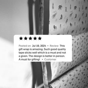 May include: Five rolls of wrapping paper with different animal designs. The designs include a variety of animals, including lions, elephants, giraffes, and dinosaurs. The wrapping paper is white with black and gray animal illustrations. The text on the image reads: "Posted on Jul 19, 2024 Review This gift wrap is amazing. Such good quality tape sticks well which is a must and not a given. The design is better in person. A must for gifting! &bull; Customer"